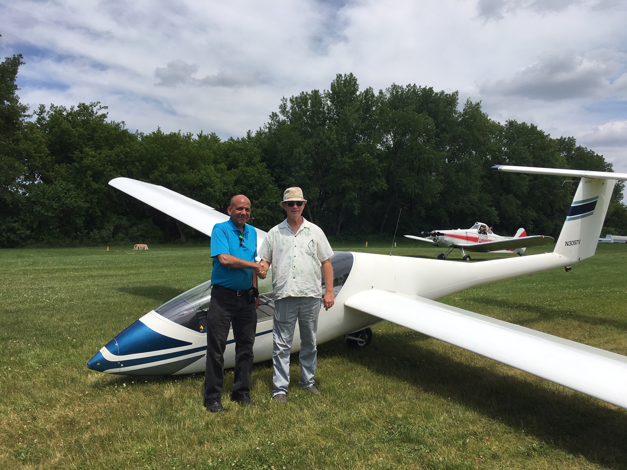 Steve Snyder congratulates Frank Smith on his solo flight with TowPilot Aaron in the background